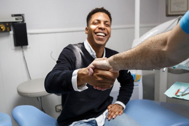 Dental implant surgery patient in Alexandria smiling