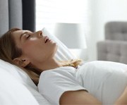 Dental implant surgery patient in Alexandria recovering at home