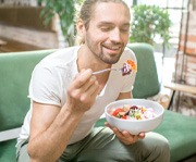 Dental implant surgery patient in Alexandria eating