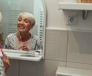 Dental implant surgery patient in Alexandria brushing their teeth