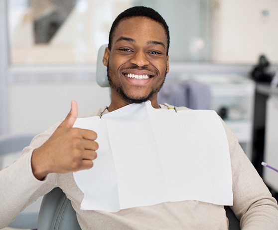 Dentist pointing at image on computer monitor