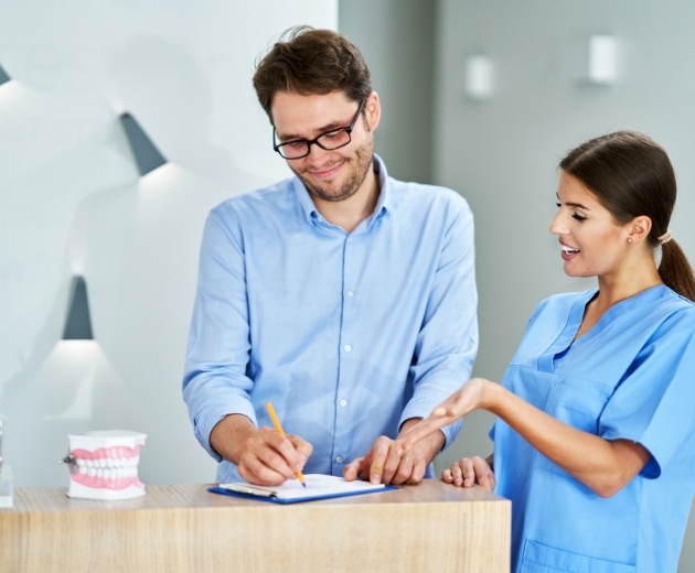 Mother and daughter filling out dental and medical insurance forms