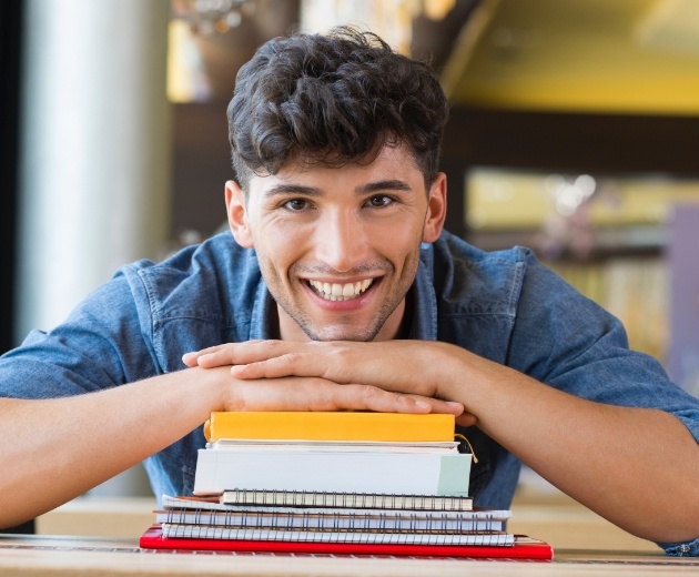 Young man smiling after wisdom tooth extractions